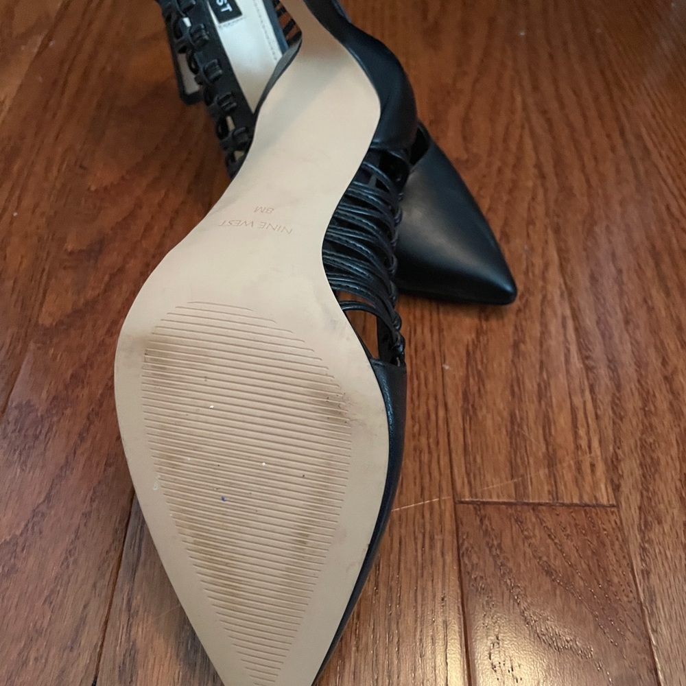 Nine West black heels with cut out sides.